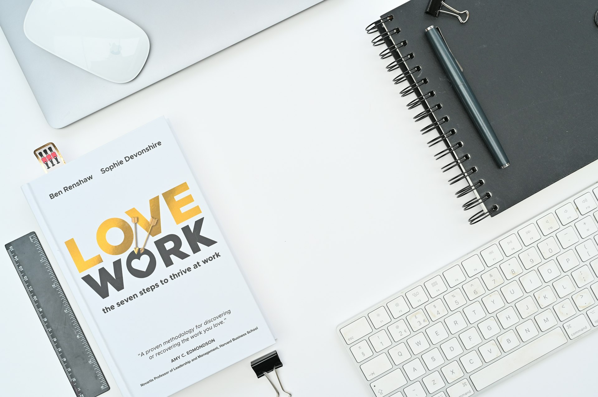 a book sitting on top of a desk next to a keyboard